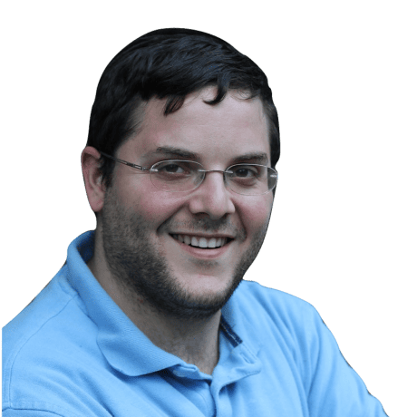 Moshe Kolodny, smiling with glasses against a black background.