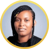 Portrait of a person with long braided hair, wearing a black top, and looking straight at the camera against a light gray background. The image has a yellow circular border.